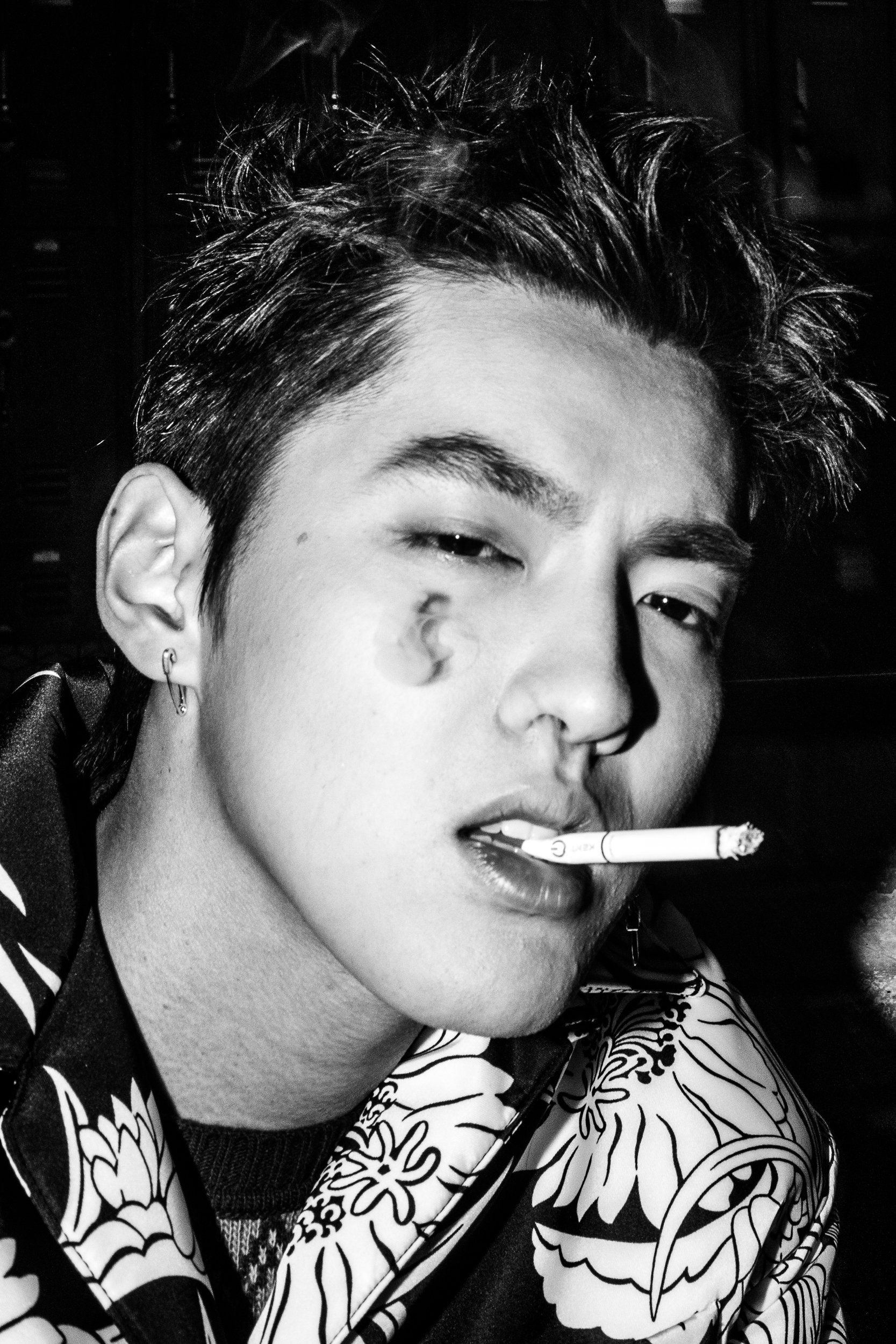 A close up of a young man smoking