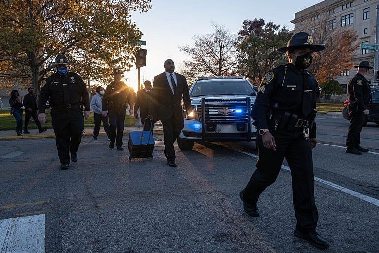 Officers from the sheriff's department in Flint, Mich. take absentee ballots filled out by people in pretrial custody for counting on Tuesday—just some of the votes being tallied that could determine the outcome of the U.S. election. (Seth Herald/AFP/Getty Images)