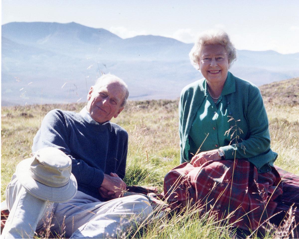 In this 2003 photo released by Buckingham Palace Friday April 16, 2021, a personal photograph of Queen Elizabeth II and Prince Philip Duke of Edinburgh at the top of the Coyles of Muick, Scotland, in this photo taken by Sophie The Countess of Wessex in 2003. (The Countess of Wessex/Buckingham Palace via AP)