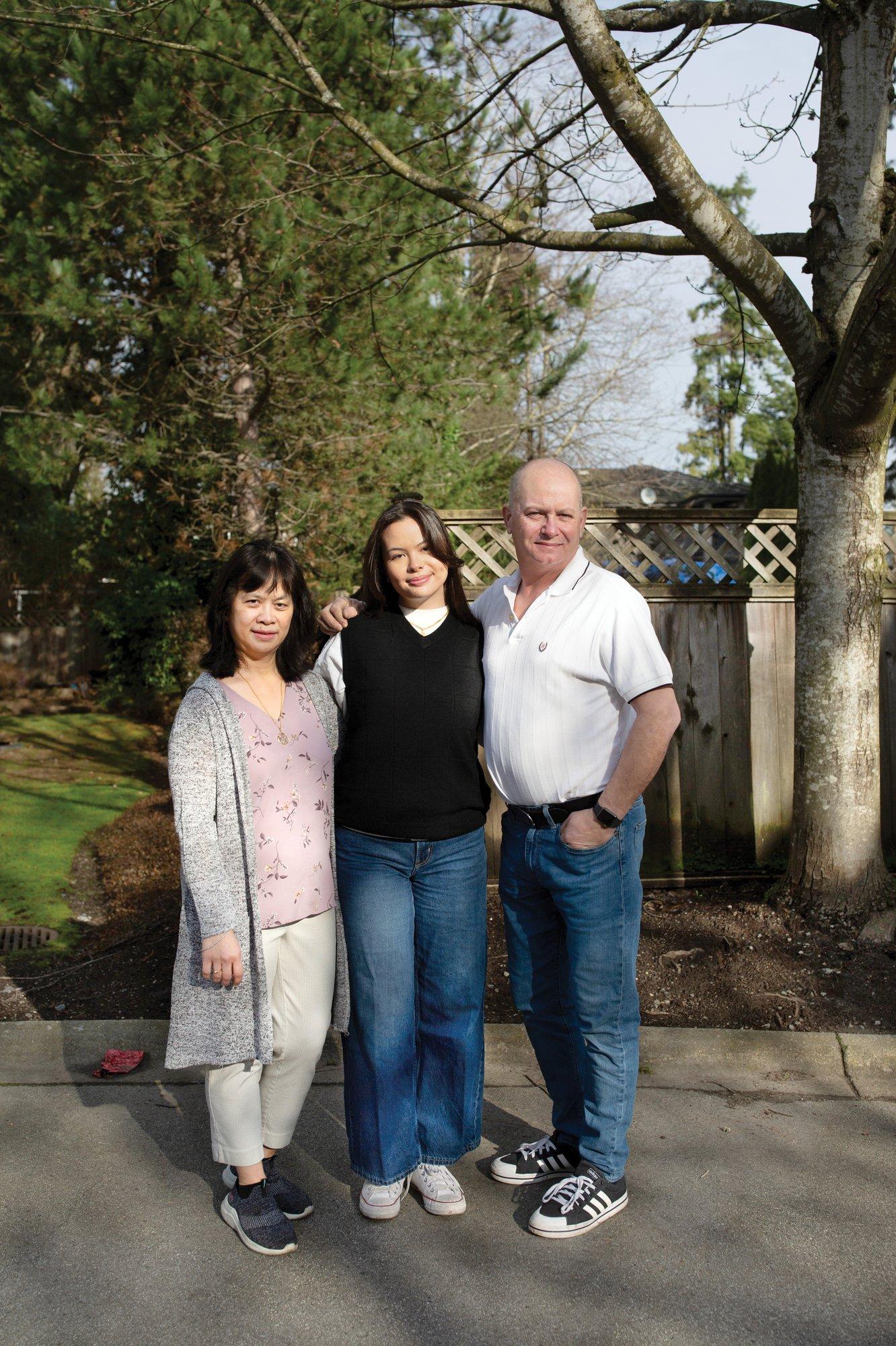 Kameela Nash (center) poses for a photo with her father Richard Nash (right) and her mother Lynda Nash (left) at their home in Surrey, B.C. on February 4, 2024.