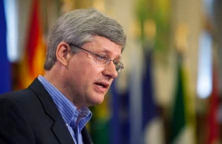 Harper touts economic achievements in caucus speech