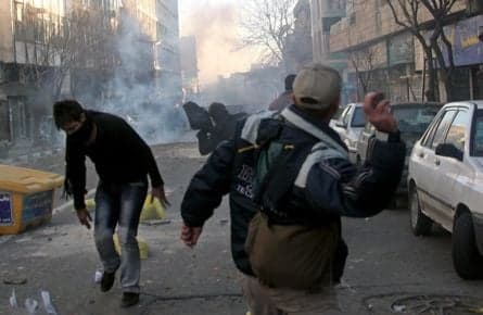 Iranian protesters hit with tear gas and paintballs
