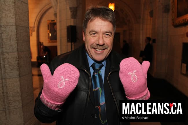 Peter Stoffer puts on the pink mittens