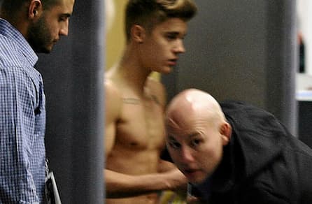 Justin Bieber's neighbour says singer attacked him and why can't he keep his shirt on?