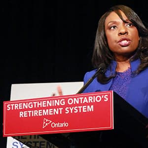 Touting Ontario's new pension on Harper's turf