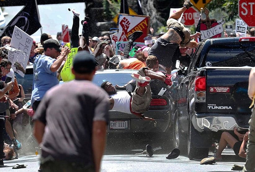 People are thrown into the air as a car drives into a group of protesters demonstrating against a white nationalist rally in Charlottesville, Va., on Aug. 12, 2017. The white nationalists were holding the rally to protest plans by the city of Charlottesville to remove a statue of Confederate Gen. Robert E. Lee. There were several hundred counterprotesters marching in a long line when the car drove into a group of them. (Ryan M. Kelly/The Daily Progress/AP/CP)