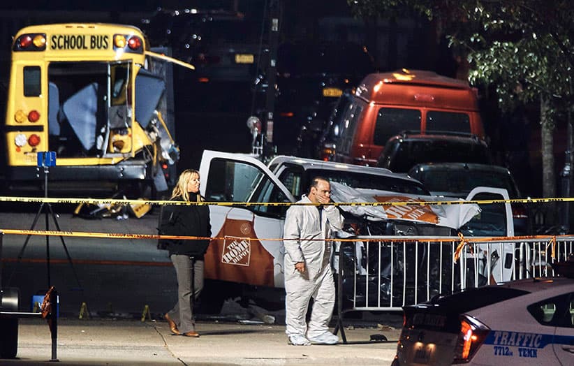 Police work near a damaged Home Depot truck Wednesday, Nov. 1, 2017, after a motorist drove onto a bike path Tuesday near the World Trade Center memorial, striking and killing several people, in New York. (Andres Kudacki/AP)