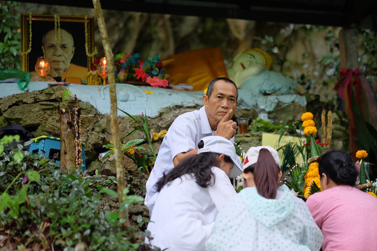 Relatives pray at a shrine on the front of Tham Luang Nang Non cave on June 28, 2018, in Chiang Rai. (Linh Pham/Getty Images)