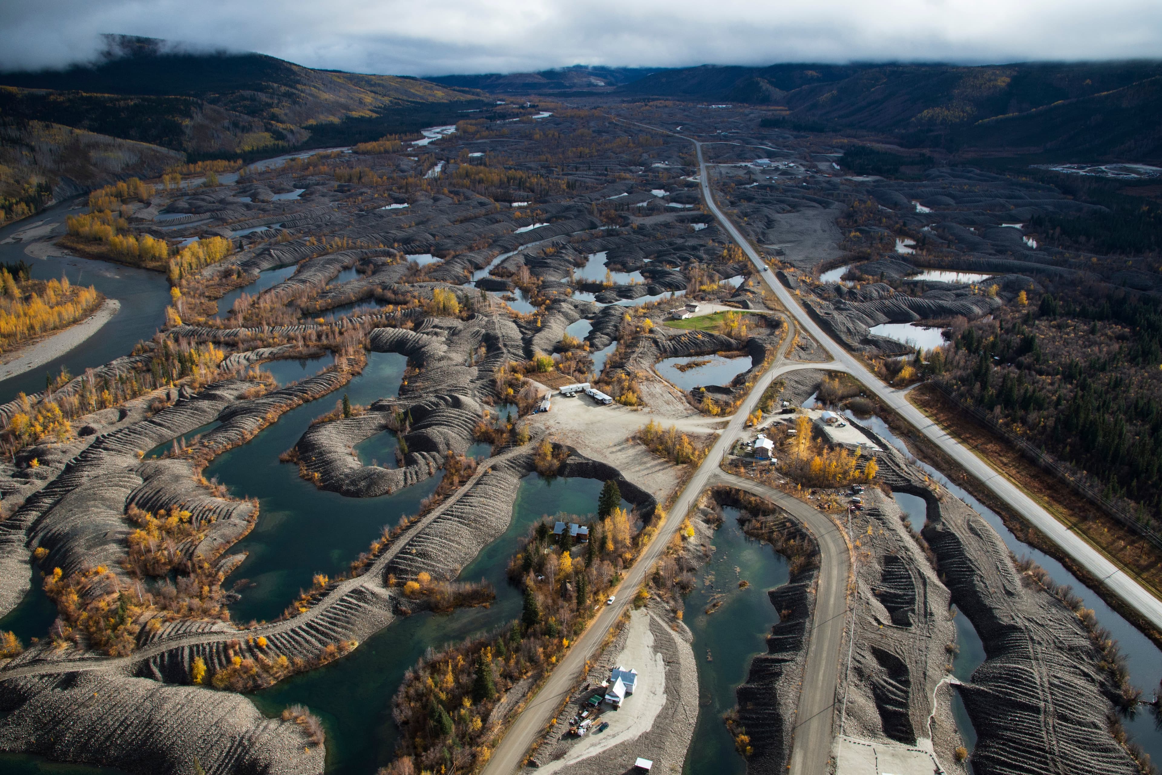Placer mining in the Klondike Valley. Americans on the Yukon River worry about the effect of placer mining in salmon spawning rivers, while Canadians are concerned by overfishing on the Alaskan portion of the River. Before the Gold Rush, the Klondike River was one of the best spawning rivers in the entire Yukon Watershed. Placer mining throughout the Klondike has devastated the salmon run in the region. Placer mining on some creeks, can create wonderful salmon spawning habitats, but their has always been conflict between salmon conservationists and placer miners. Hopefully, in the future miners and fish biologists can work together to the benefit of all. (Peter Mather)