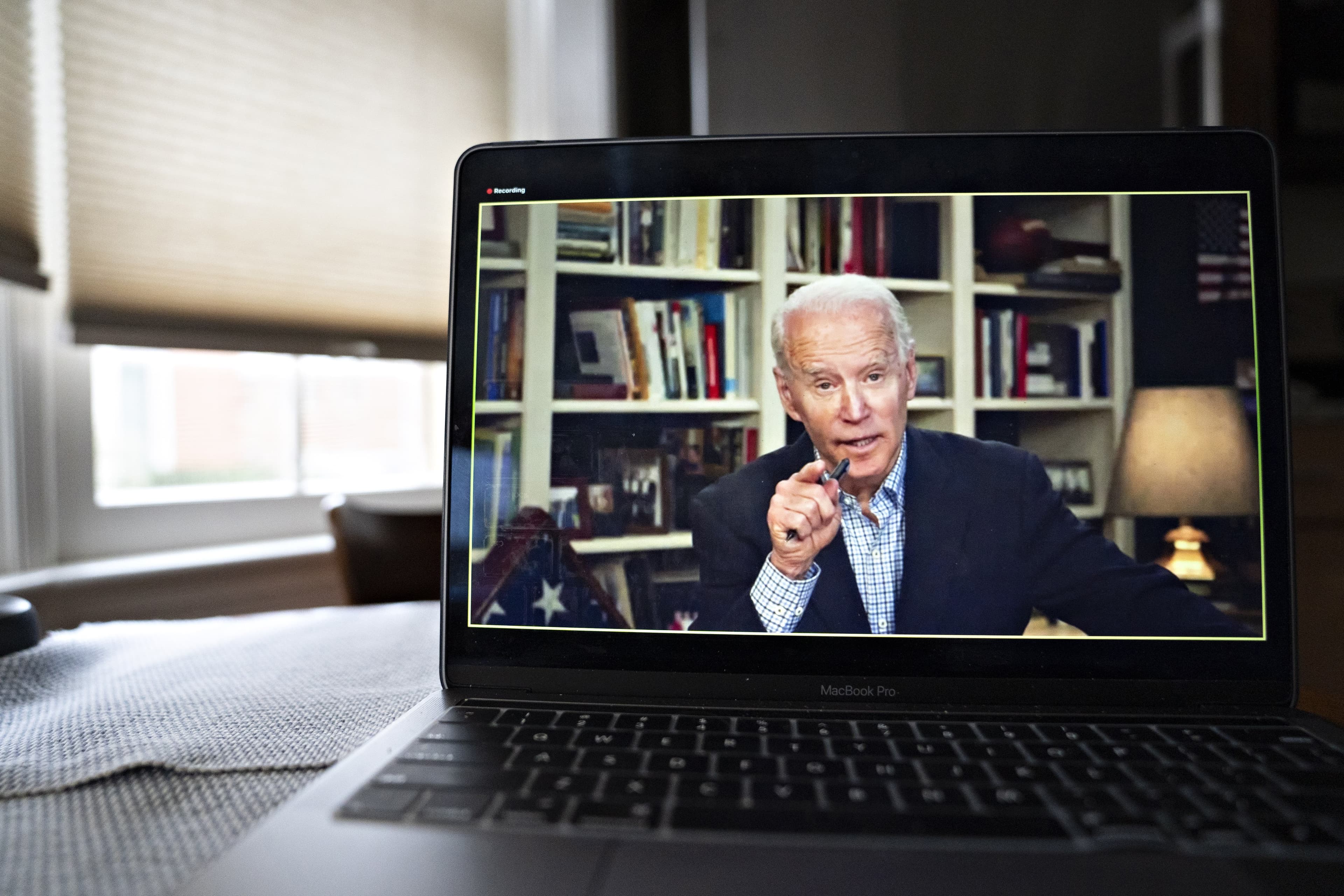 Biden held a virtual briefing on March 25; the flag that covered his son’s coffin sat behind him (Andrew Harrer/Bloomberg/Getty Images)