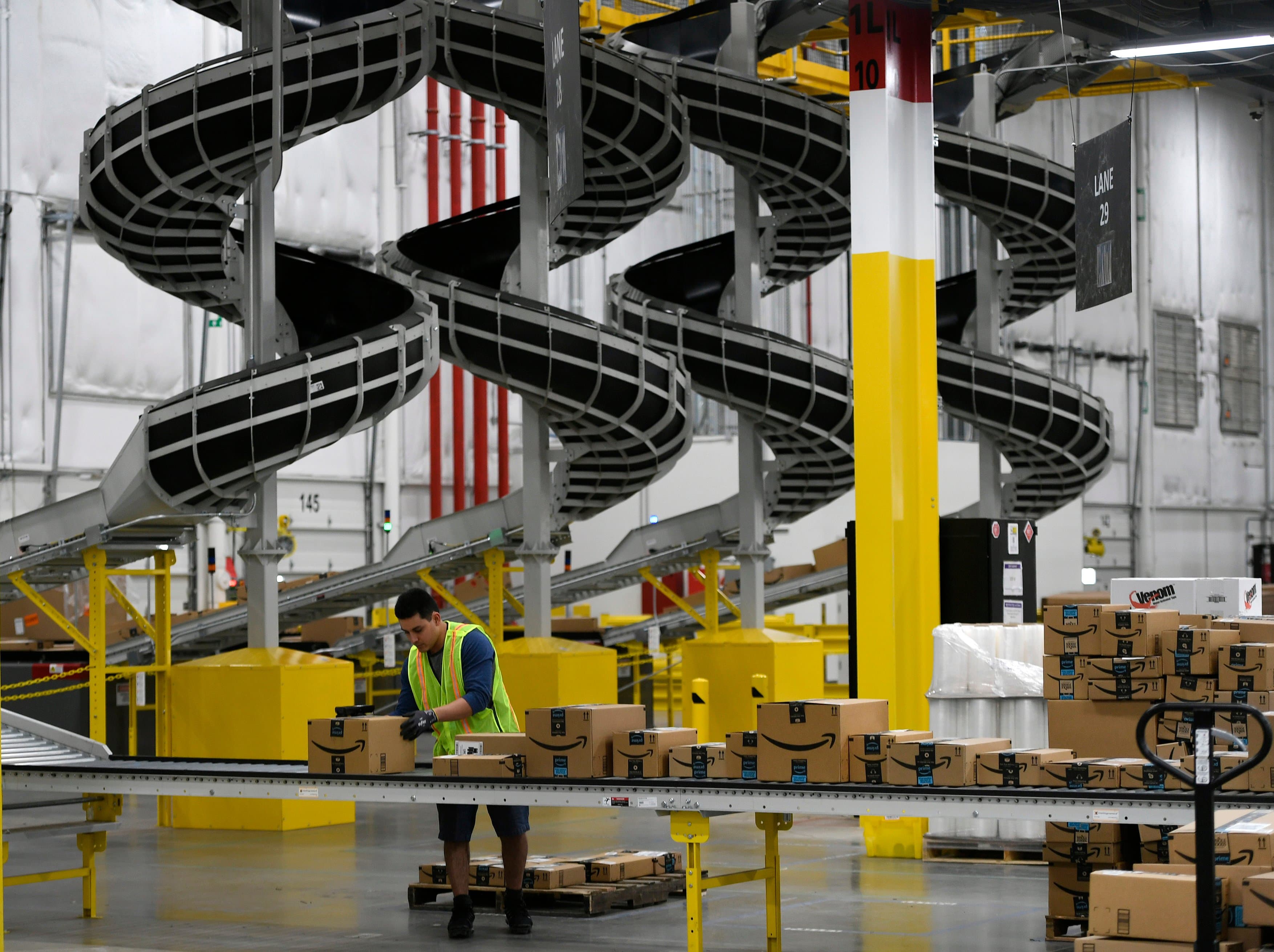 THORNTON, CO - FEBRUARY 19: A warehouse associate checks labels on boxes before they are loaded on to trucks to be shipped out at Amazon's Fulfillment Center on March 19, 2019 in Thornton, Colorado. The facility which opened in July of 2018 is 855,000 square feet, and employees over 1500 people. The Thornton facility is a state-of-the-art facility that uses Amazon Robotics to move the merchandise around from one area to the next. Hundreds of workers perform a variety of jobs in the huge facility. Many workers stand at stations, picking items to ship from trays brought to them by robots that roam the massive warehouse floor. The robotic facility, near I-25 and 144th Avenue, distributes small- and medium-sized items and allows for quicker delivery of orders in the metro area. (Helen H. Richardson/The Denver Post / Getty Images)