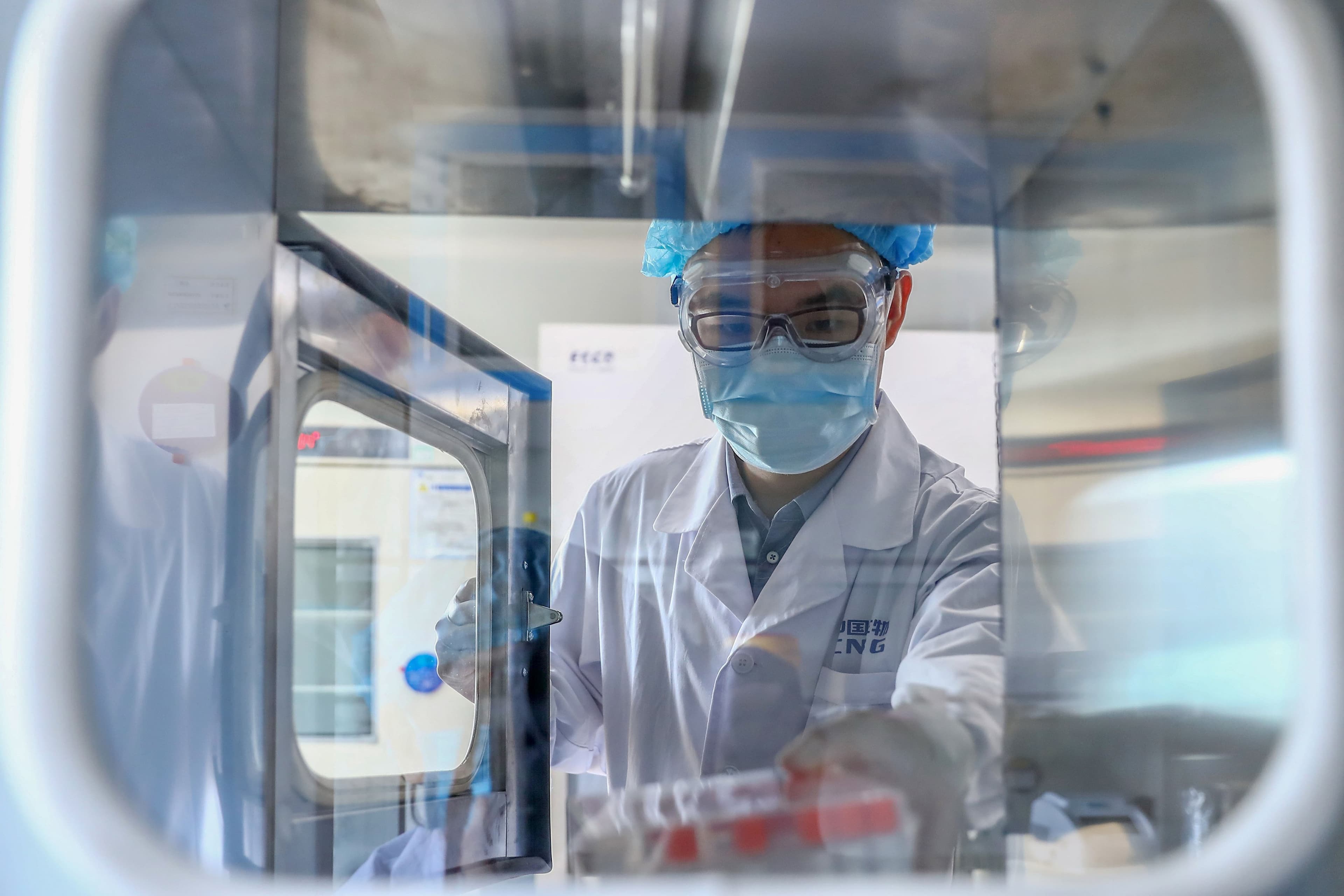 A staff member takes out samples of a COVID-19 vaccine candidate at a production plant of China National Pharmaceutical Group Sinopharm in Beijing (Zhang Yuwei/Xinhua/Getty Images)