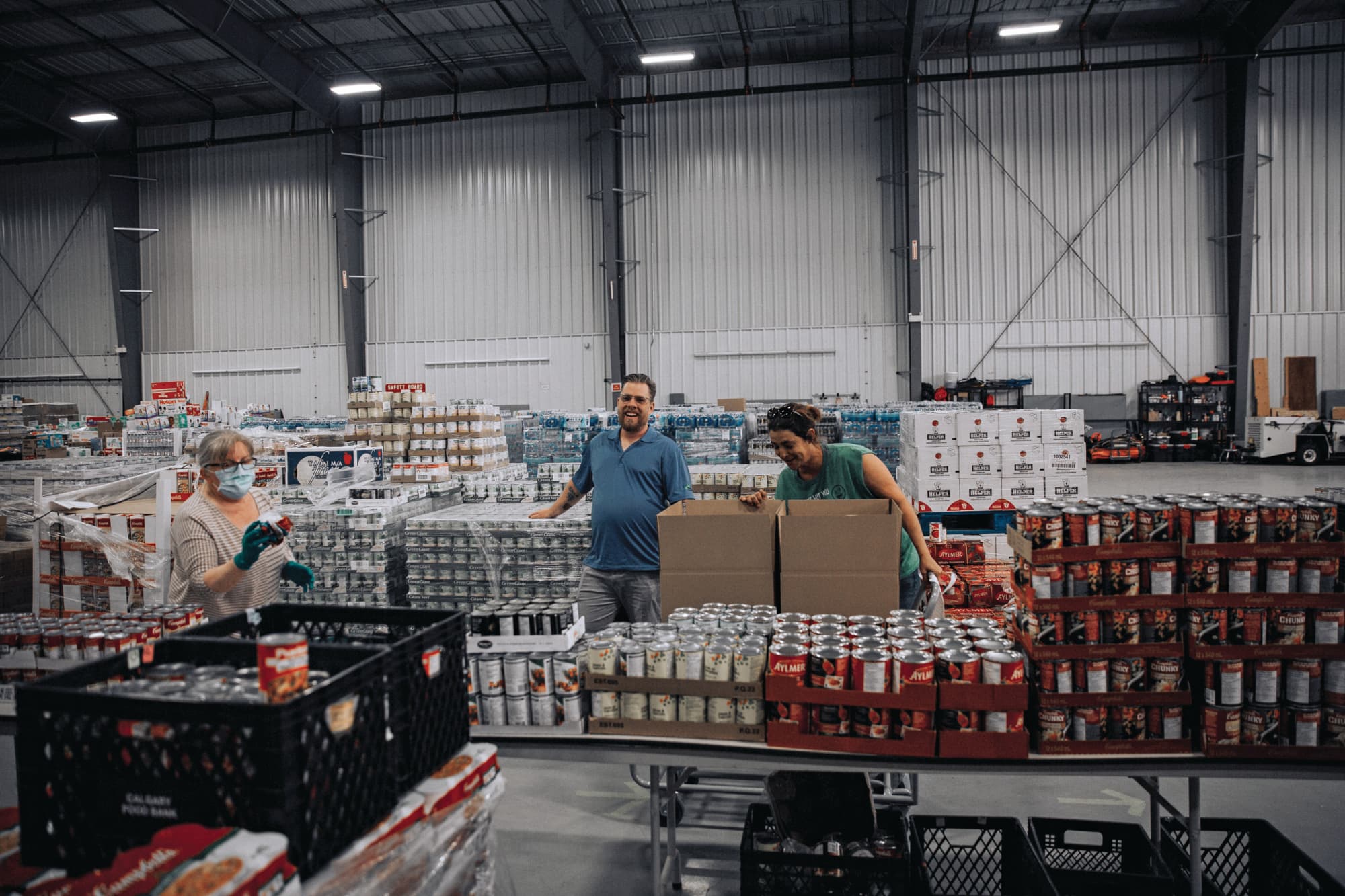 Edwards (centre) says food bank supplies lost in the floods were quickly replaced by donations (Photograph by Serghei Cebotari)