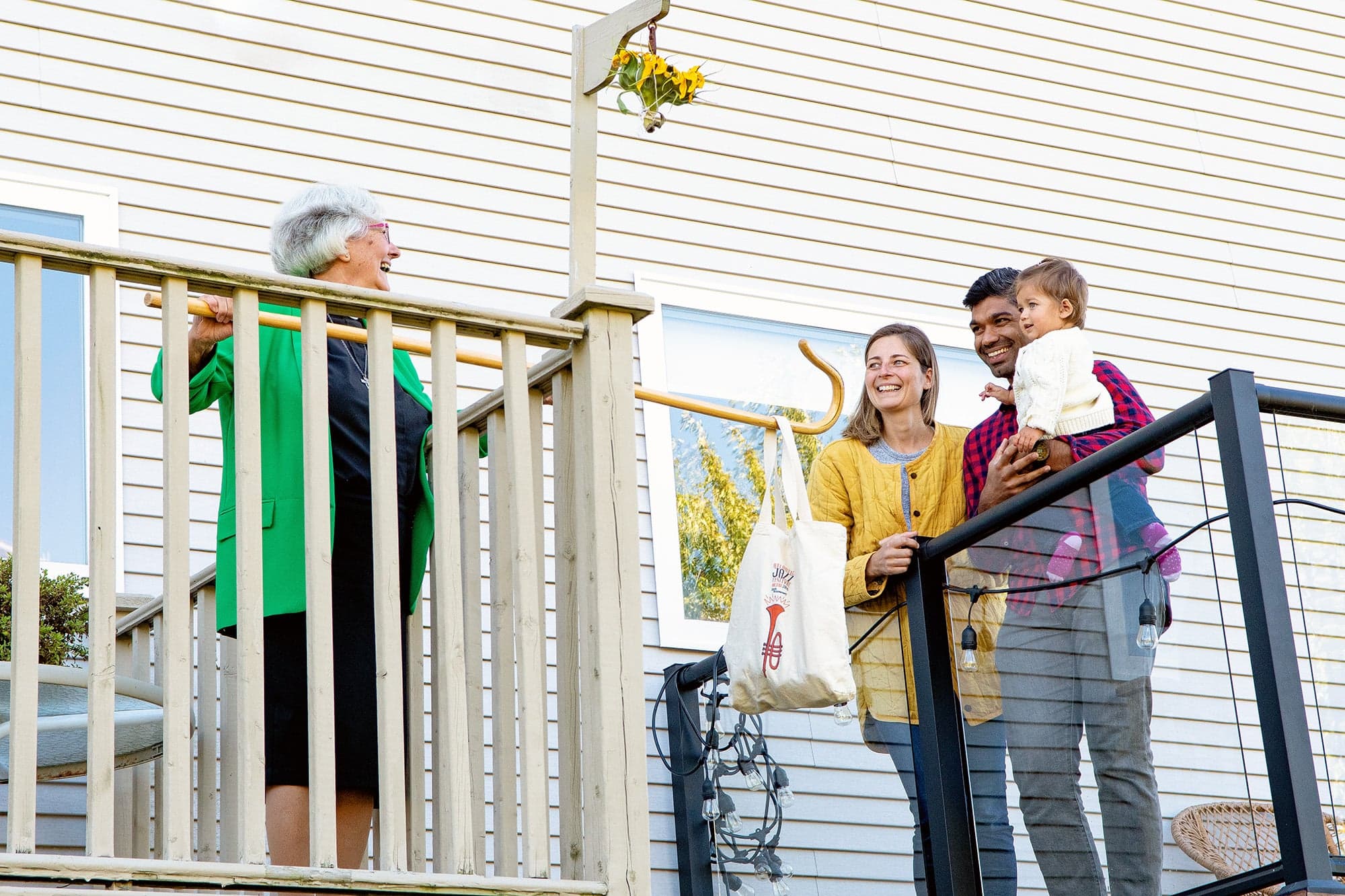 Parker (left) added a lower level to her front porch to allow for socially distanced visits and safe baking exchanges (Photograph by Aaron McKenzie Fraser)