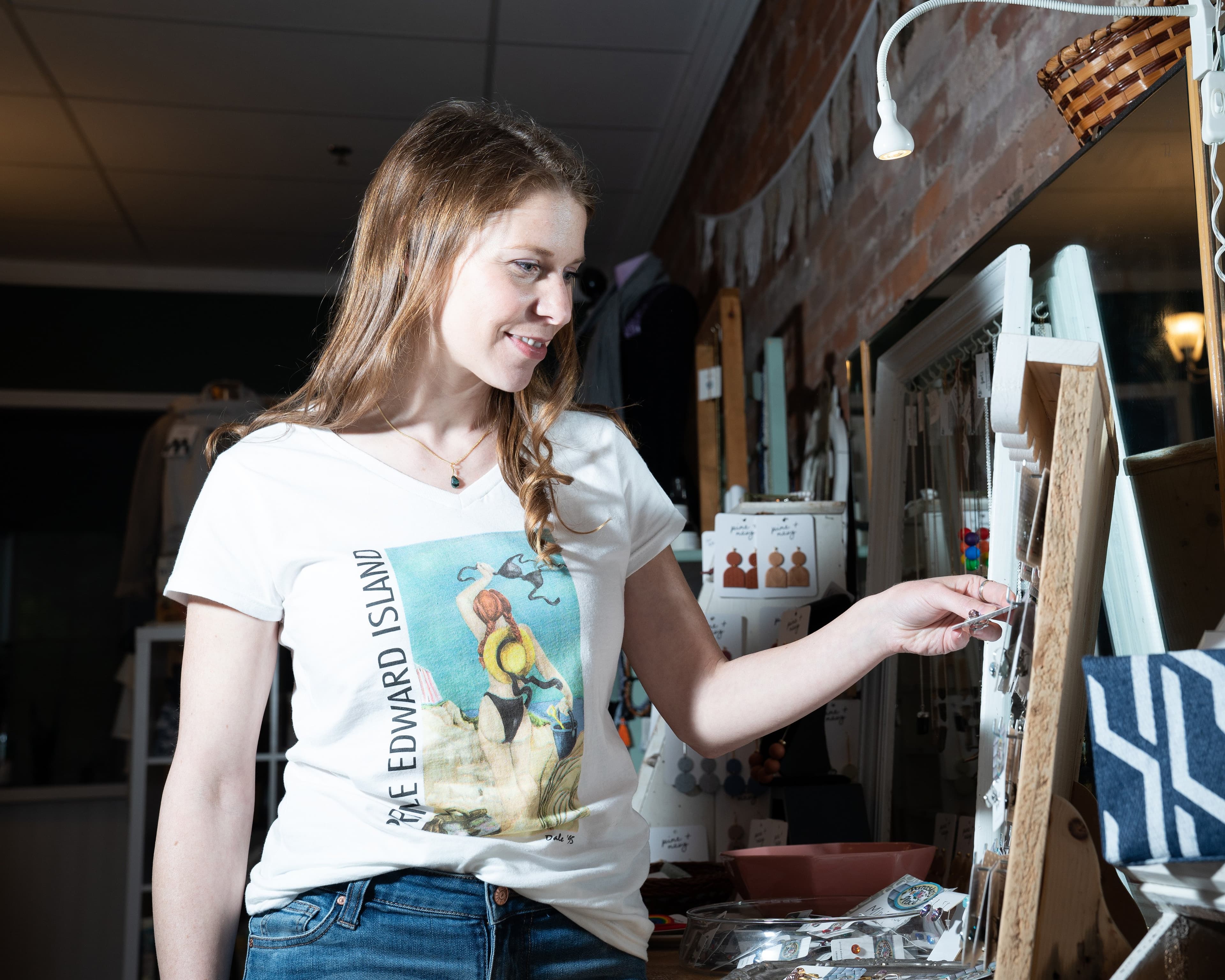 Savannah Belsher-MacLean inspects some jewelry in her store, Green Eye Designs, in Charlottetown, PEI on September 18, 2020. (Photograph by John Morris)