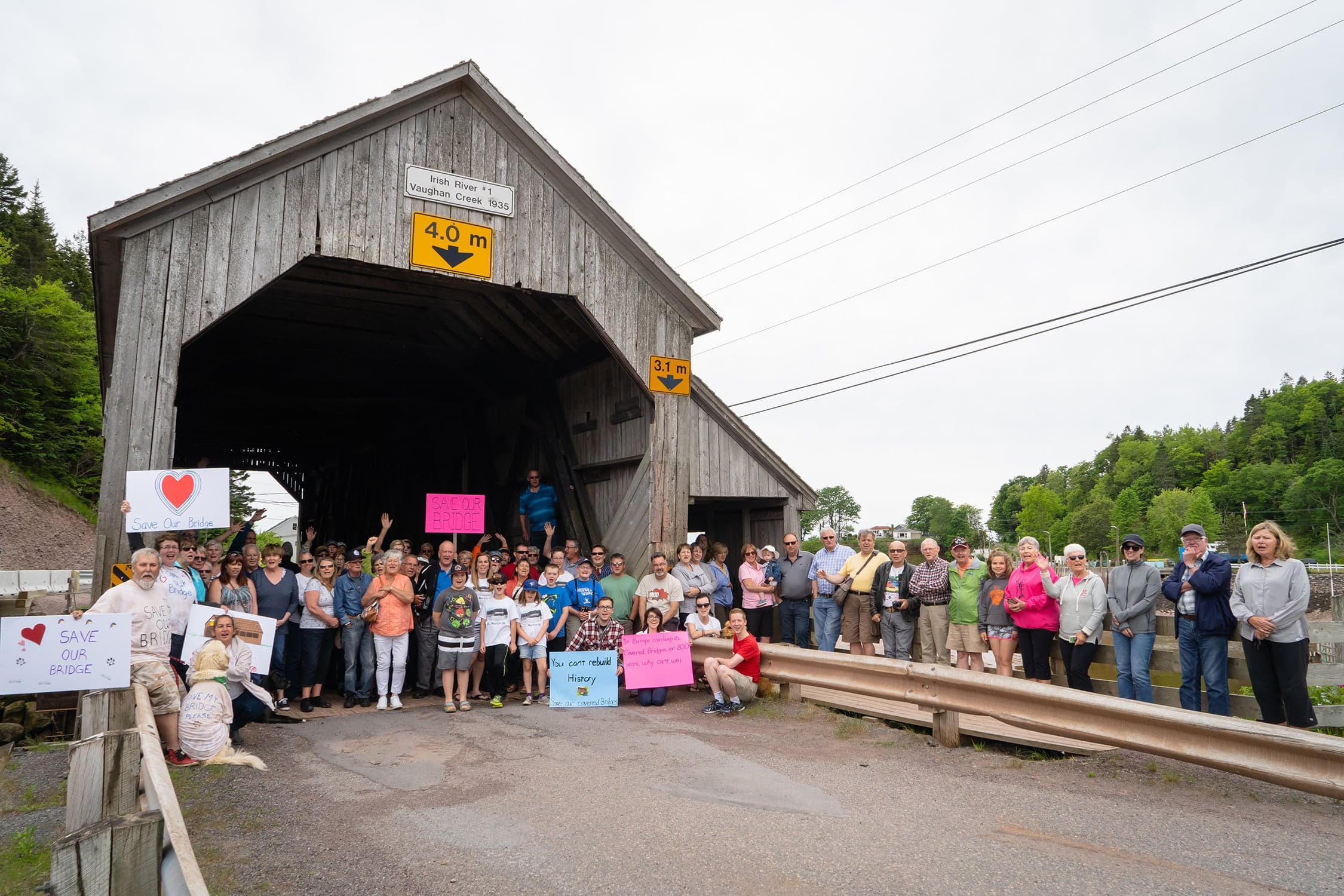 The St. Martins Rally was the start of a province-wide petition signing event sponsored by the Covered Bridges Conservation Association of New Brunswick. The Vaughan Creek Covered Bridge was chosen as the kick-off location because of the threat to its destruction. That particular day saw 290 signatures from the St. Martins area whose population numbers about 350. In just three consecutive Sundays they collected over 3,500 signatures. The petition became a part of the presentation to the provincial government in 2019. (Courtesy of Nicholas Lowe Photography)