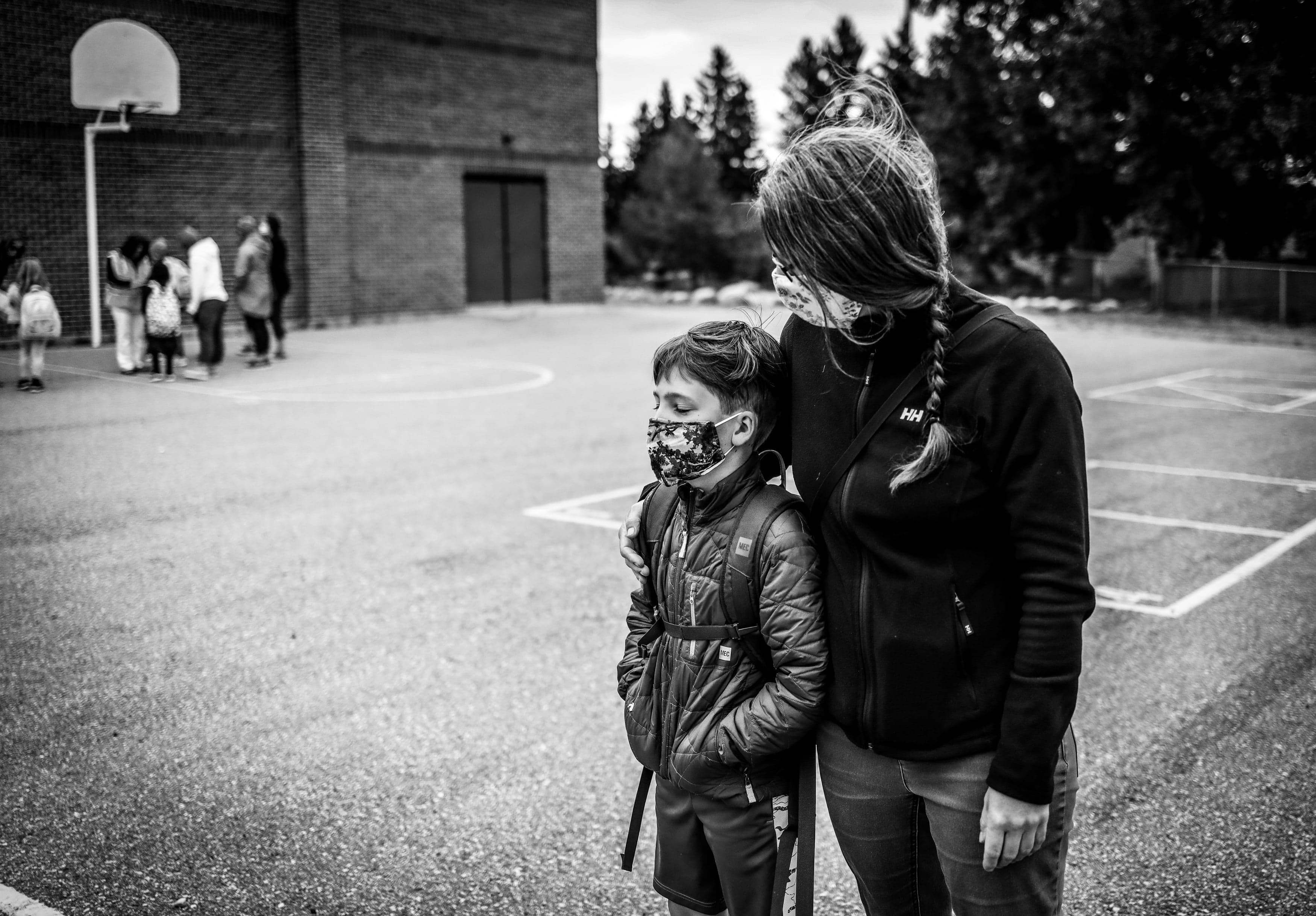 Karilynn Simpson waits in the schoolyard with her son William on his first day of Grade 4 in Calgary, on Sept. 2, 2020 (Leah Hennel)