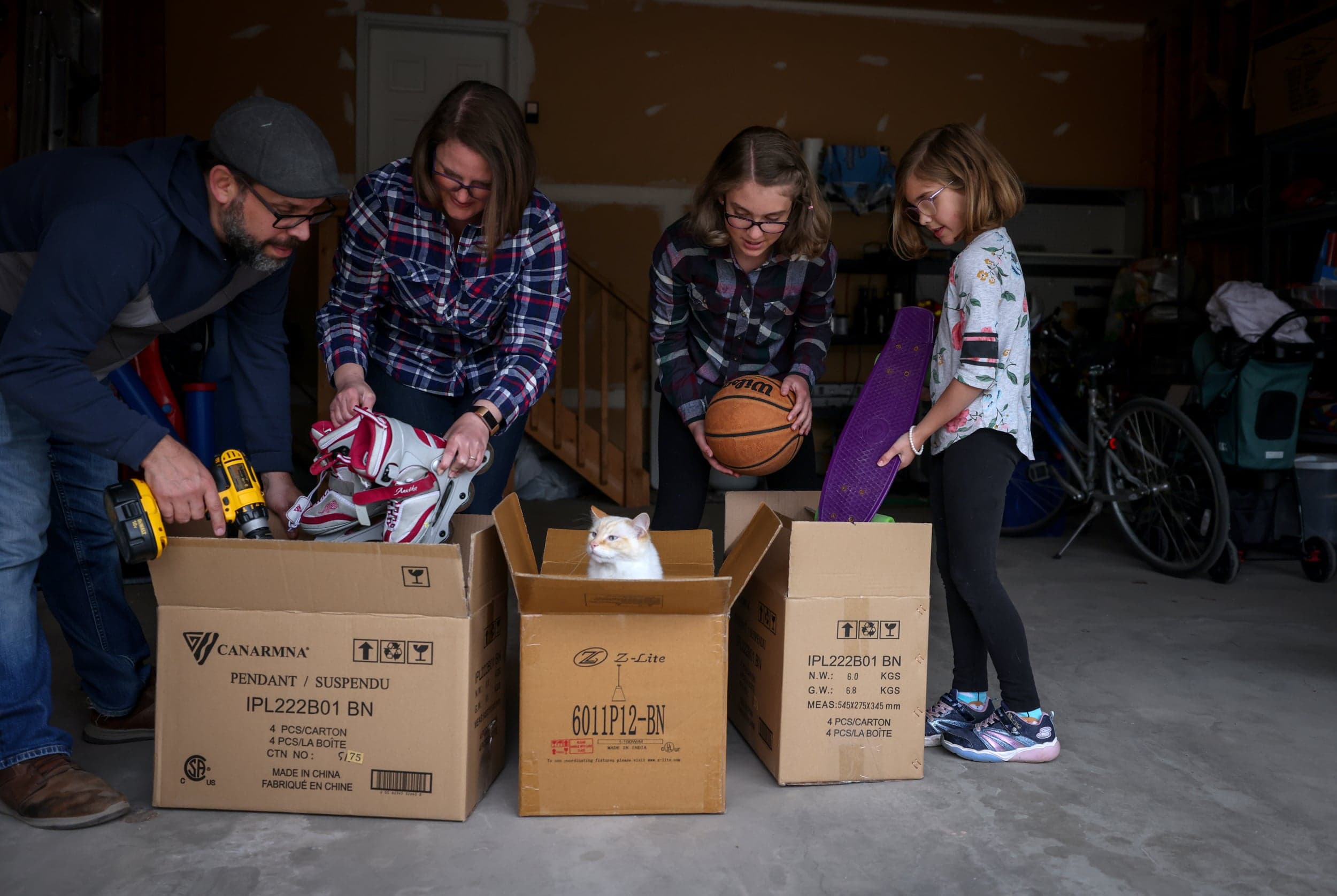 Iturriaga (left), his wife Emily, Evelyn, 12, and Bronwyn, 8, pack up their home in Calgary (Photograph by Leah Hennel)