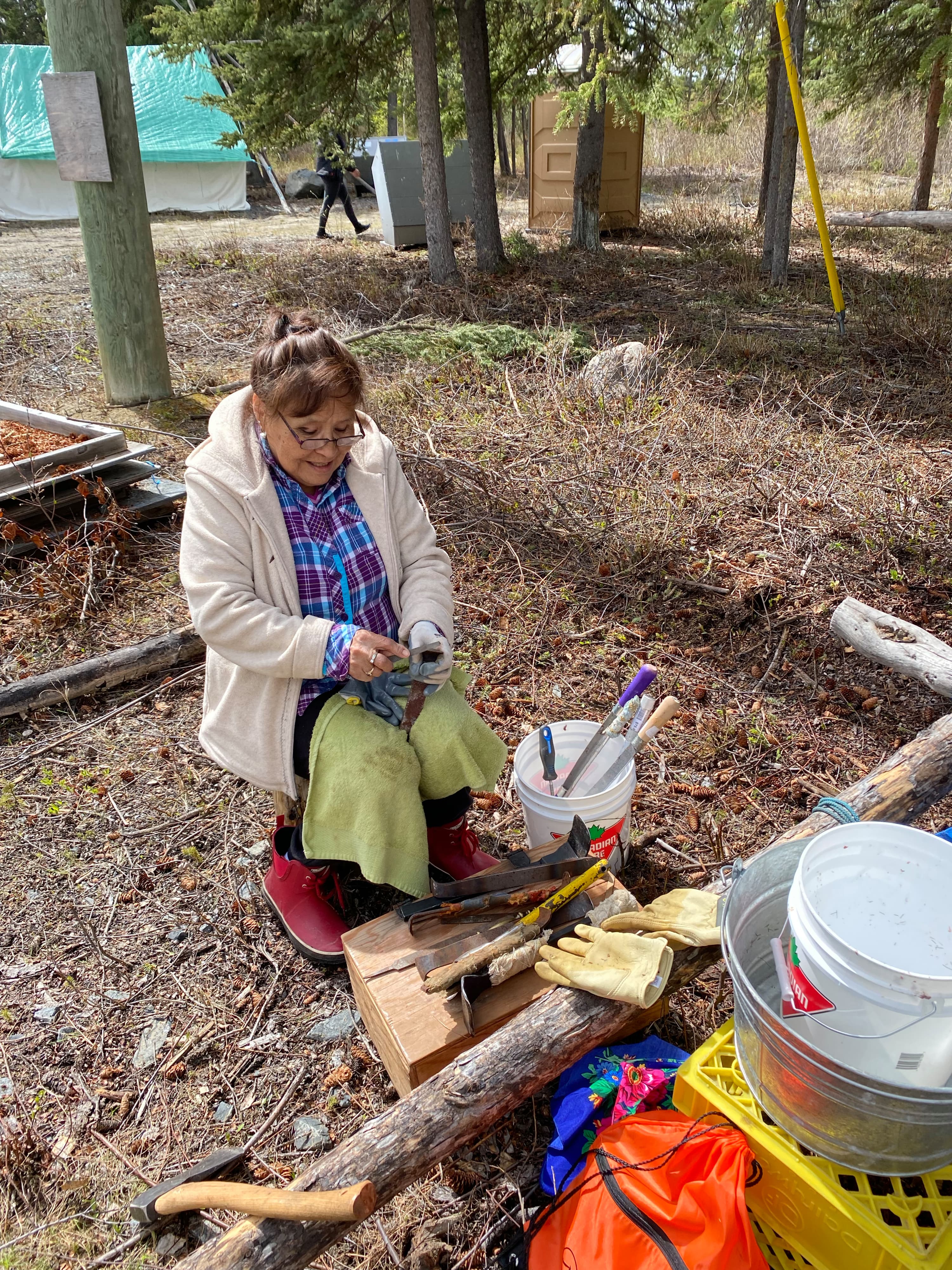 Alice Wifladt sharpens her tools for fleshing and scraping moosehide. (Courtesy of Kyla LeSage/Dechinta Centre for Research and Learning)