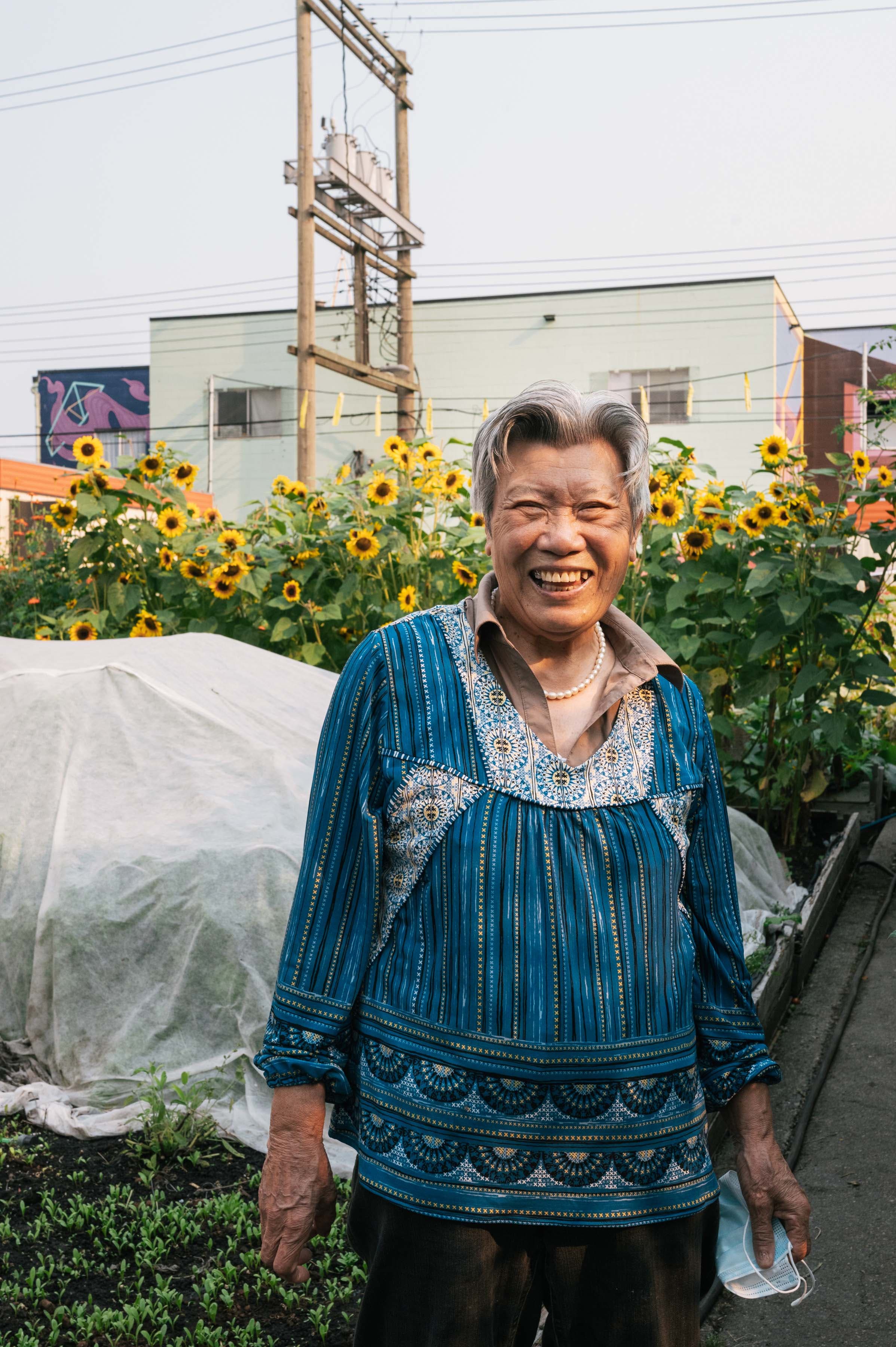 A portrait of Chinese senior, Yu Ying Guan, 83, who enjoys her Friday mornings in the DTES neighbourhood house urban farm, caring for the vegetables her and her friends planted in two boxes. (Photograph by Felicia Chang)