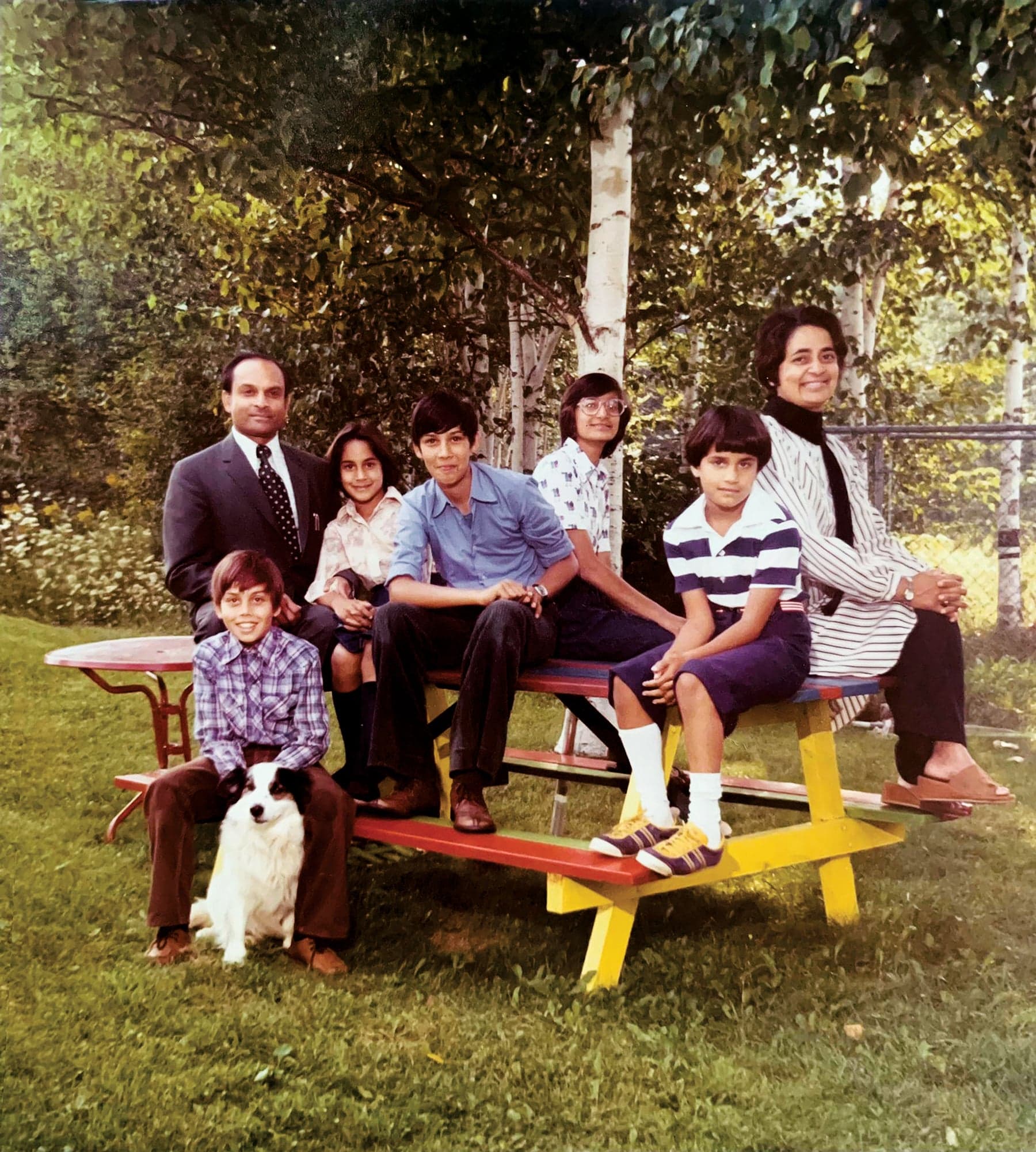 Anand, shown here with her parents and cousins in the backyard of her childhood home, grew up in Kentville, Nova Scotia. She appears third from left, seated next to her father. 