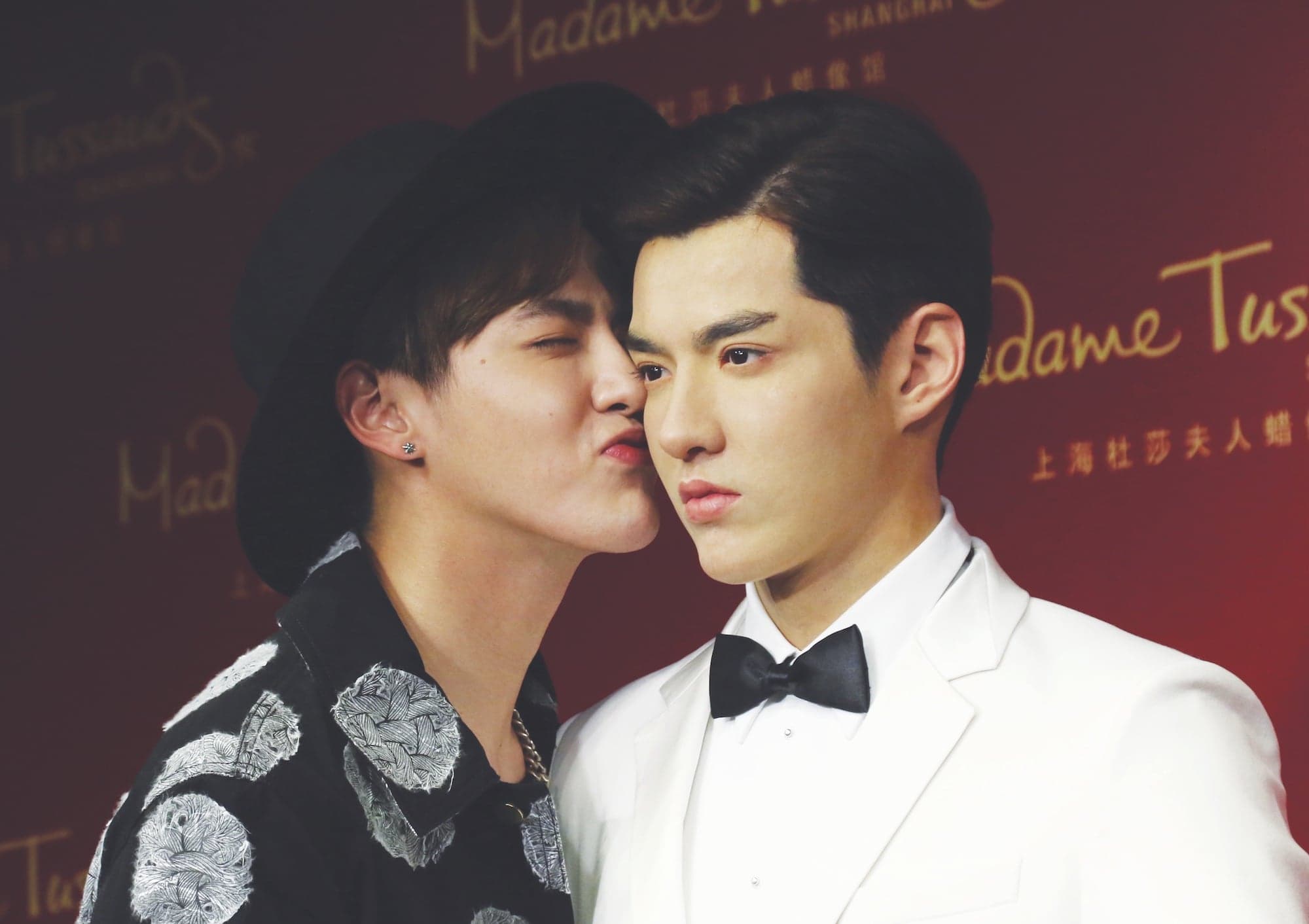 A man kisses a wax figure of himself
