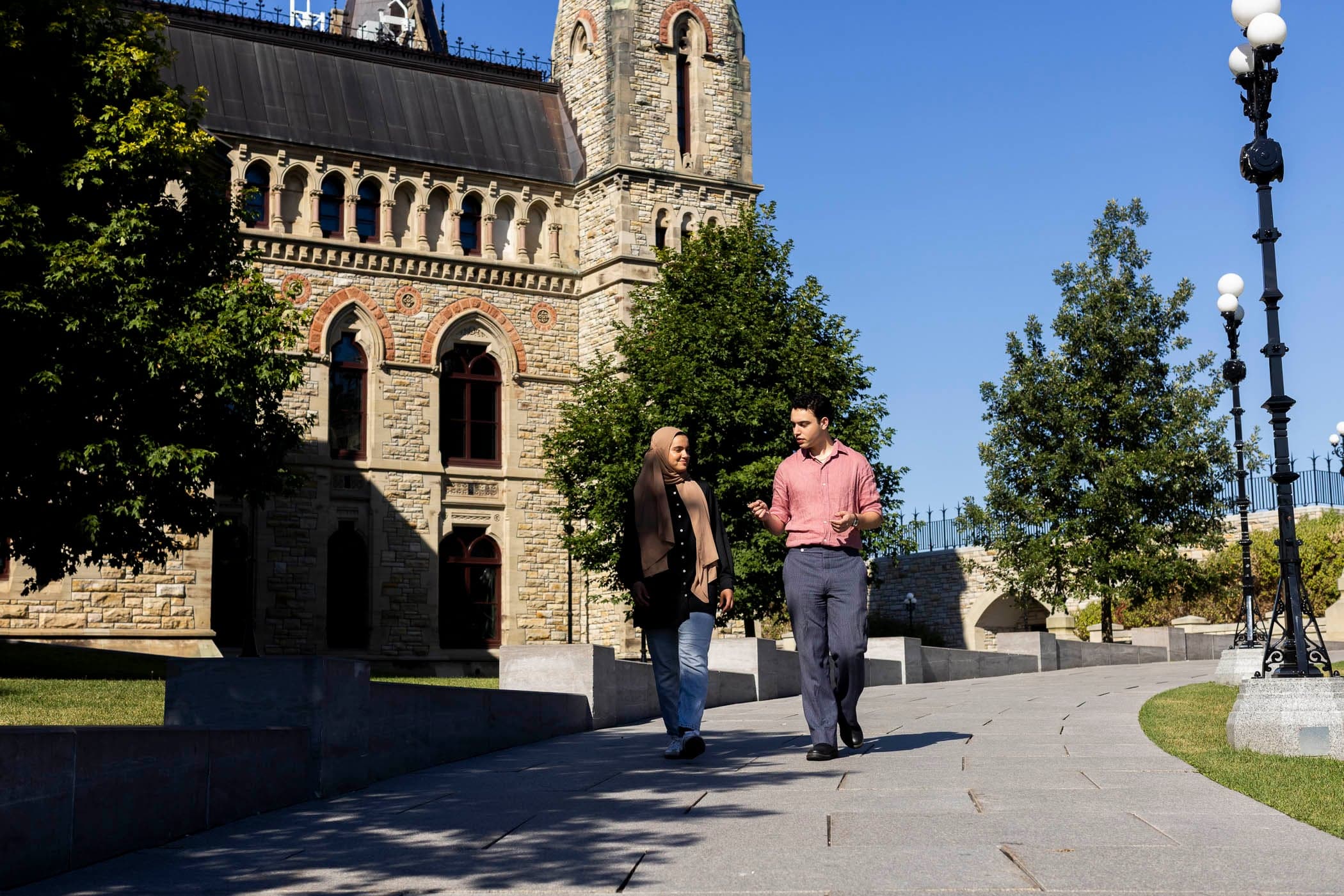 A young man walking on a university campus