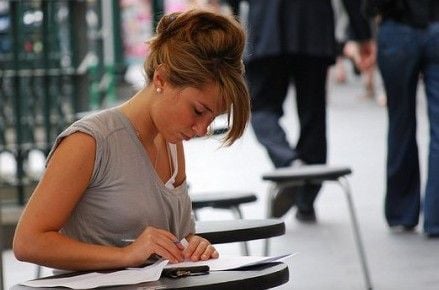 girl writing at desk