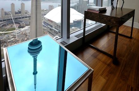 The CN Tower is reflected on an end table in the dining room of the Ritz Carlton residents model suite in Toronto May 1, 2012.