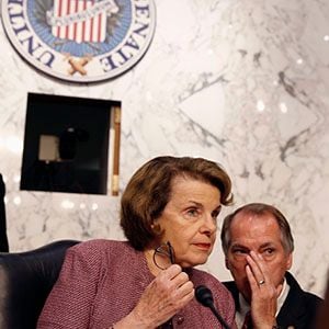 Senate Intelligence Committee Chair Senator Feinstein (D-CA) listens to an aide before the Senate Intelligence Committee hearing on the House-passed Foreign Intelligence Surveillance Act reform bill while on Capitol Hill in Washington