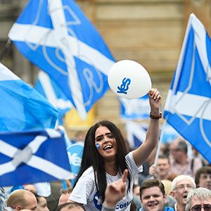 Campaigners wave Scottish Saltires at a &#8216;Yes&#8217; campaign rally in Glasgow