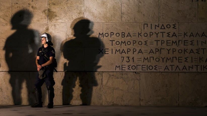 Riot police officer stands guard in front of the parliament building during an anti-austerity rally in Athens