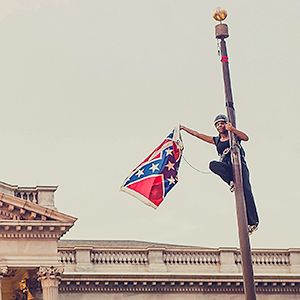 Bree Newsome takes down the Confederate Flag from a pole at the Statehouse in Columbia