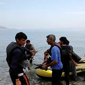Pakistani migrants arrive at the Greek island of Kos on a dinghy