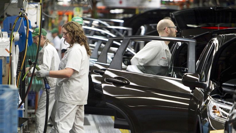 Production Associates inspect cars moving along assembly line at Honda manufacturing plant in Alliston, Ontario.