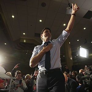 Trudeau gestures as he arrives on stage during a campaign rally in Edmonton