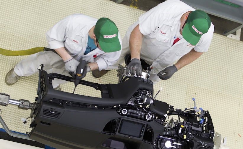 Production Associates work on dashboard assembly at Honda manufacturing plant in Alliston, Ontario.