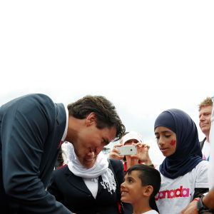 Canada&#8217;s PM Trudeau shakes hands with a Syrian refugee during Canada Day celebrations on Parliament Hill in Ottawa