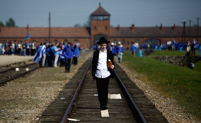 A man walks on the railway tracks in the former Nazi death camp of Auschwitz-Birkenau (Auschwitz II) as thousands of people, mostly youth from all over the world gathered for the annual &#8220;March of the Living&#8221; to commemorate the Holocaust in Brzezinka