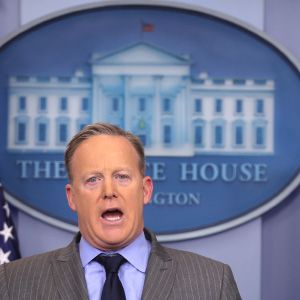 Press Secretary Sean Spicer delivers a statement while television screen show a picture of U.S. President Donald Trump&#8217;s inauguration at the press briefing room of the White House in Washington U.S.