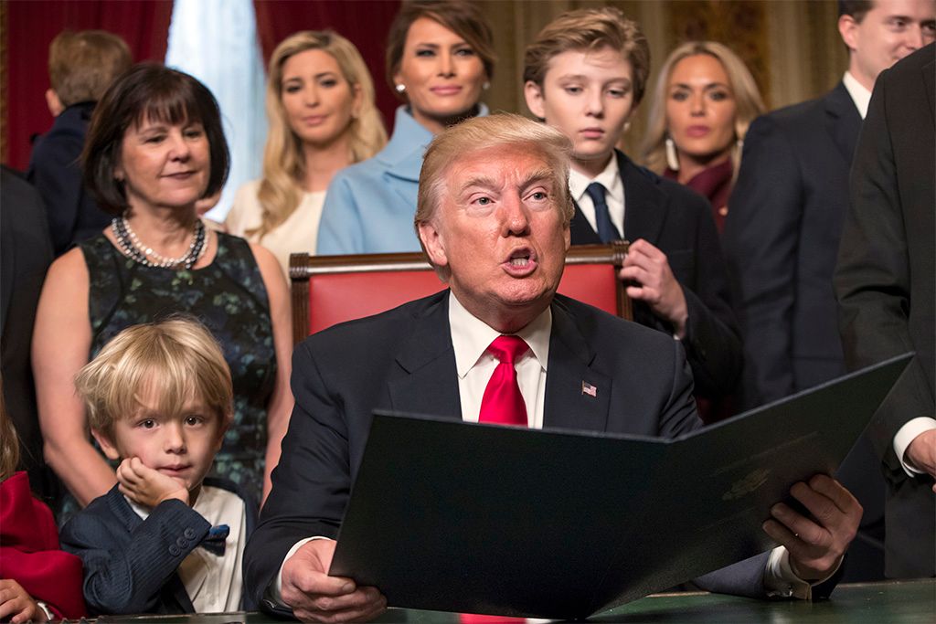 Donald Trump is joined by his family, rear, wife Melania Trump, son Barron Trump, as he formally signs his cabinet nominations into law, at the Capitol in Washington