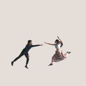 Young couple in air reaching out for each other