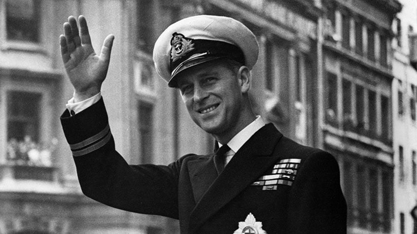 May 1948:  Prince Philip, Duke Of Edinburgh waving through the open roof of a car.  (Photo by Central Press/Getty Images)