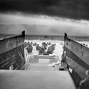Digitally restored vintage World War II photo of American troops wading ashore on Omaha Beach during the D-Day invasion on June 6, 1944.