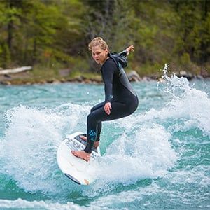 Angela Knox surfs on the Kananaskis river