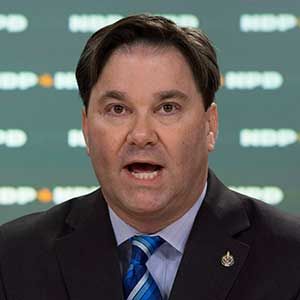 Don Davies, NDP MP and health critic, speaks during a news conference on blood plasma clinics in Ottawa in November 2016
