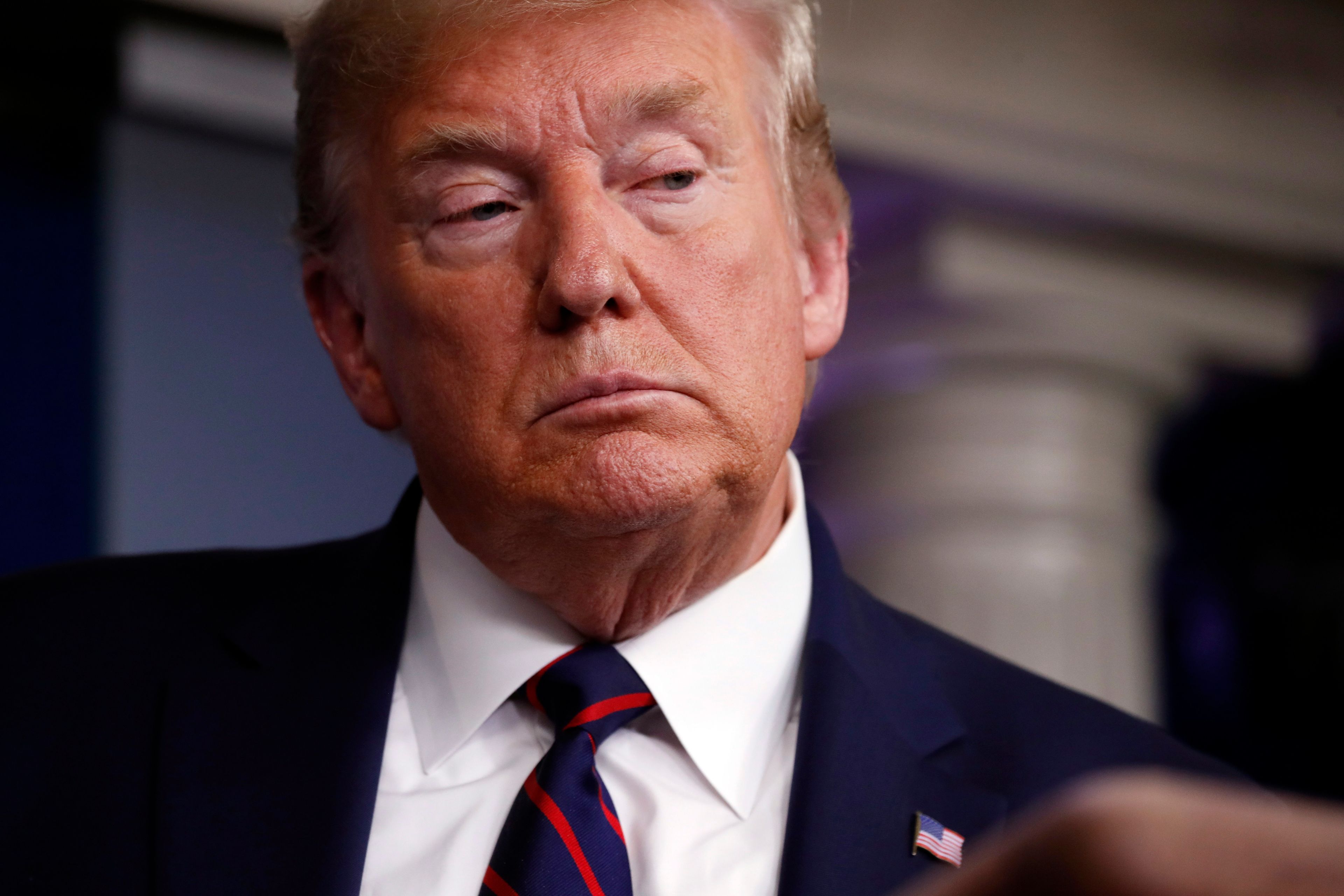In this Mar. 27, 2020 photo, President Donald Trump listens to a question as he speaks about the coronavirus in the James Brady Press Briefing Room in Washington. (Alex Brandon/AP/CP)