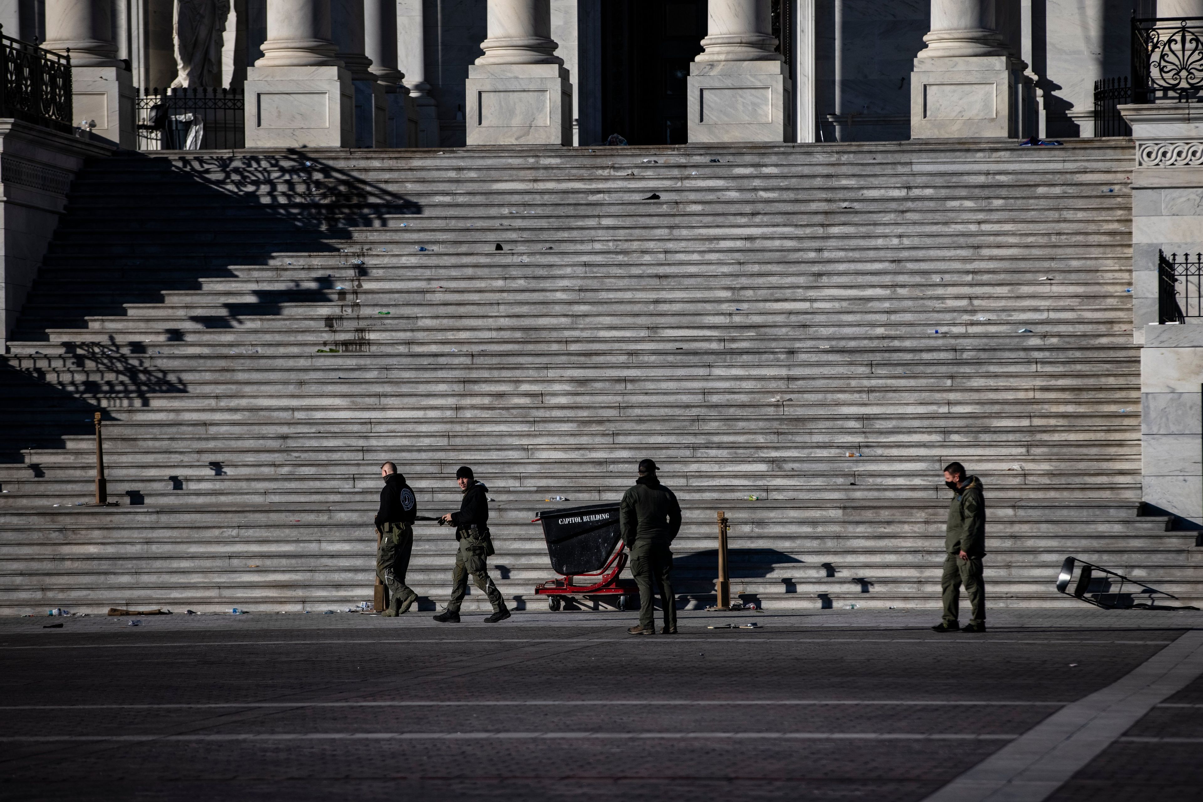 Police officers survey the damage and debris left on the Eastern steps of the U.S. Capitol Building on Jan. 7, 2021 in Washington, DC (Samuel Corum/Getty Images)
