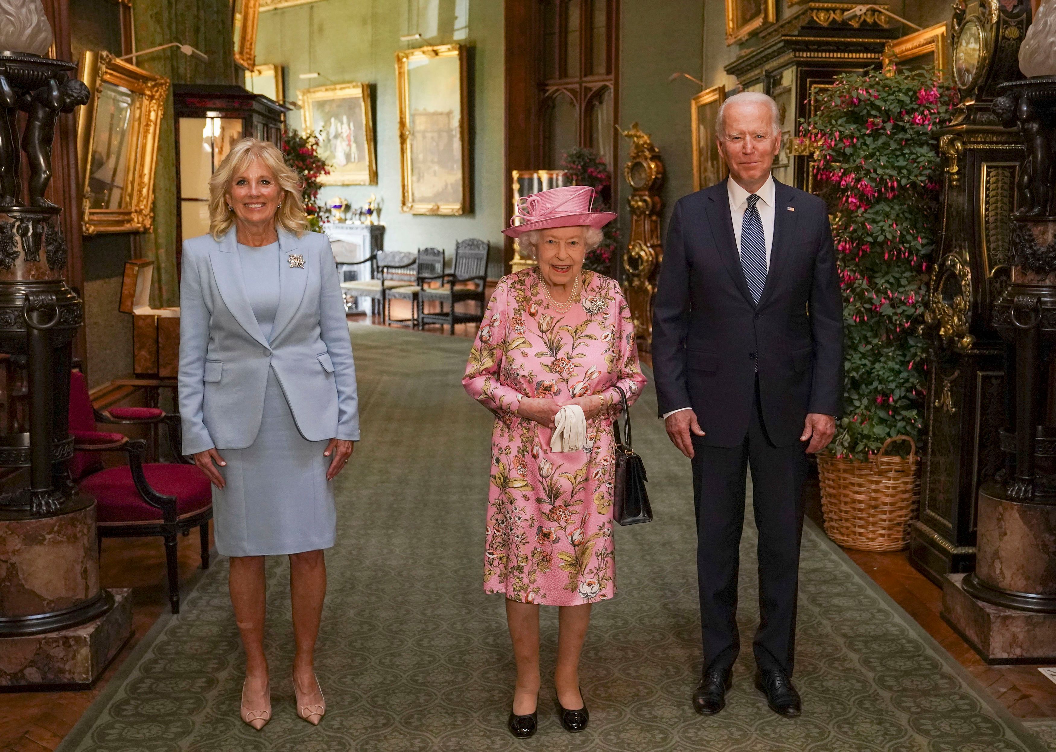 Queen Elizabeth II with U.S. President Joe Biden and his wife Jill Biden in the Grand Corridor at Windsor Castle on Sunday (Steve Parsons/Pool via AP)
