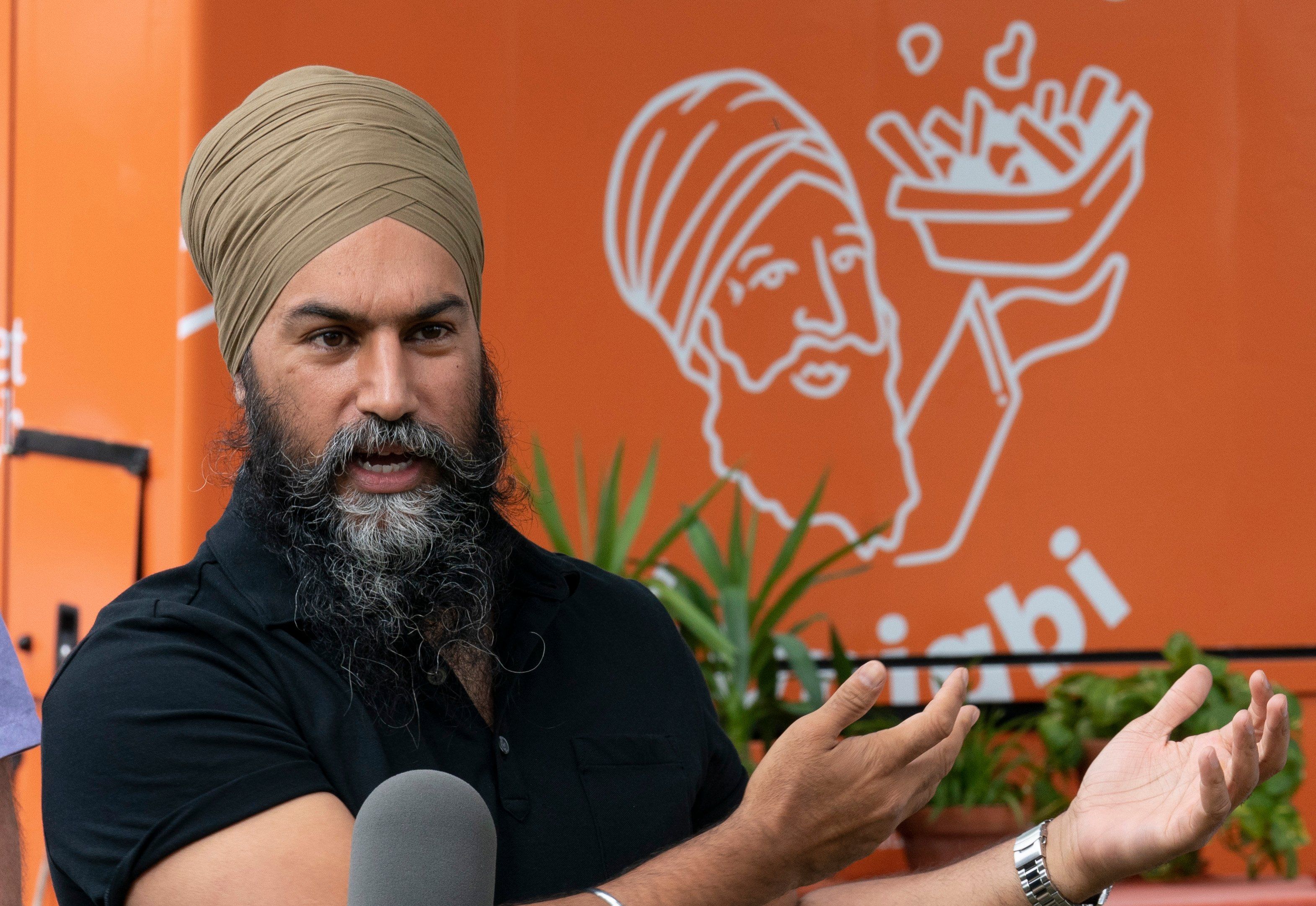 Singh addresses reporters in front of the Poutine Punjabi food truck in Montreal. (Adrian Wyld/CP)
